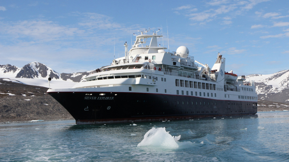 A cruise ship skirts the Monacobreen Glacier in Svalbard in the High Arctic. The new accessibility of the Arctic and the opportunities for shipping and tourism associated with that also harbour dangers.